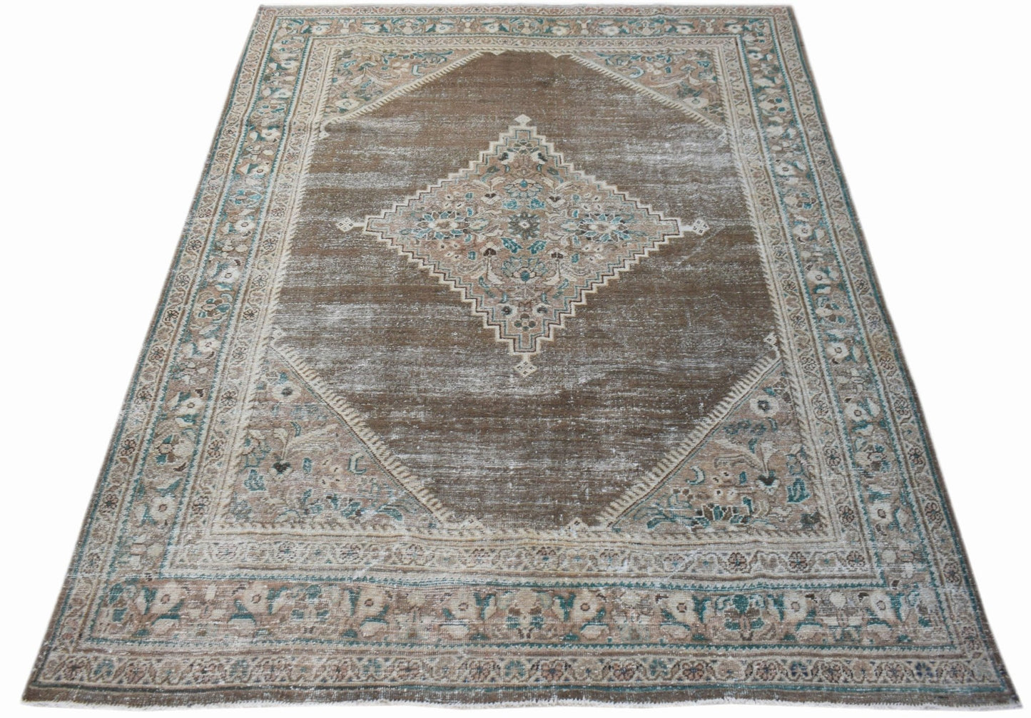 A vintage Persian Mahal rug featuring a central diamond medallion on a distressed brown field.