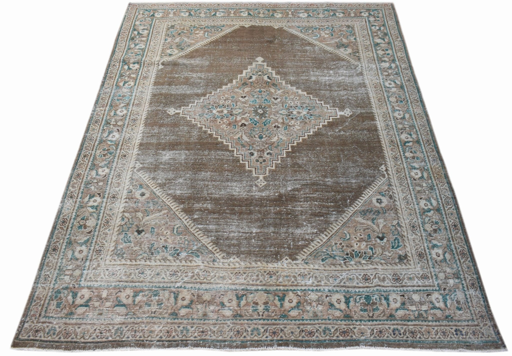 A vintage Persian Mahal rug featuring a central diamond medallion on a distressed brown field.