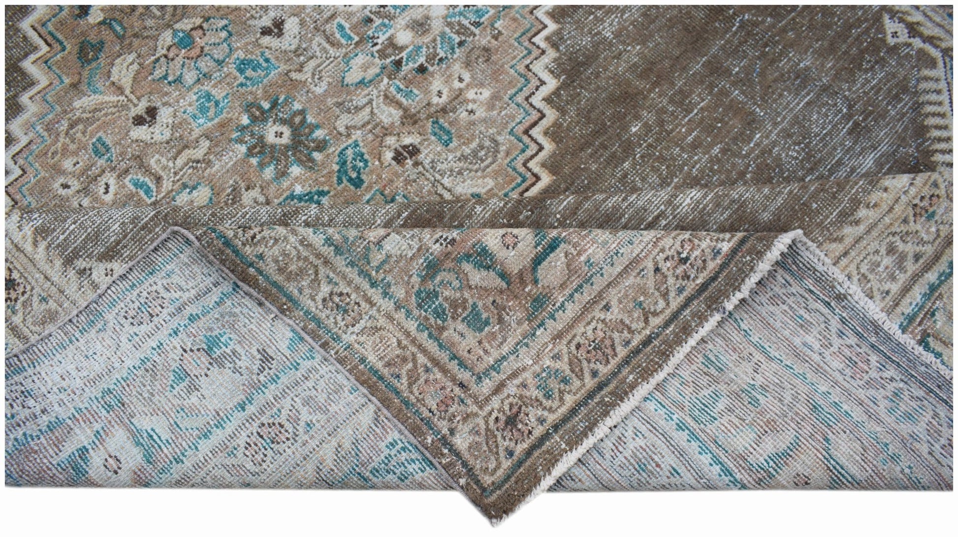 A vintage Persian Mahal rug featuring a faded floral pattern in brown and teal tones.