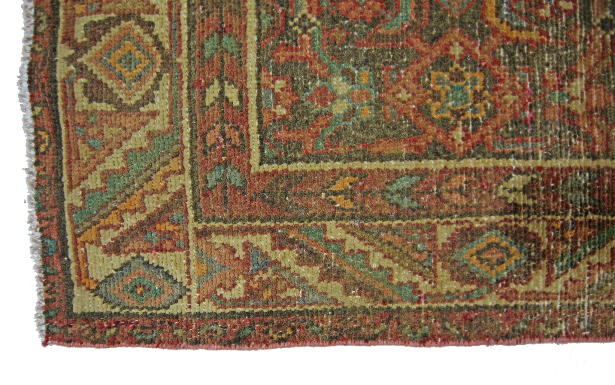 A close-up of a vintage Persian Hamadan runner featuring intricate geometric patterns in wool.