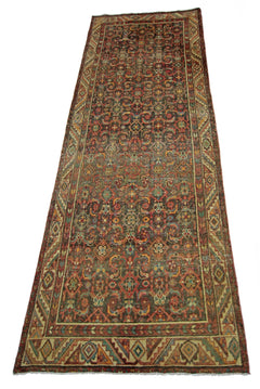 A vintage handmade Persian Hamadan runner featuring a detailed floral pattern in earthy tones.