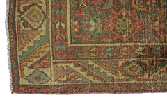 A close-up of a vintage Persian Hamadan runner featuring intricate geometric patterns in wool.