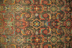 A vintage Persian Hamadan runner featuring a detailed geometric floral pattern in earthy tones.