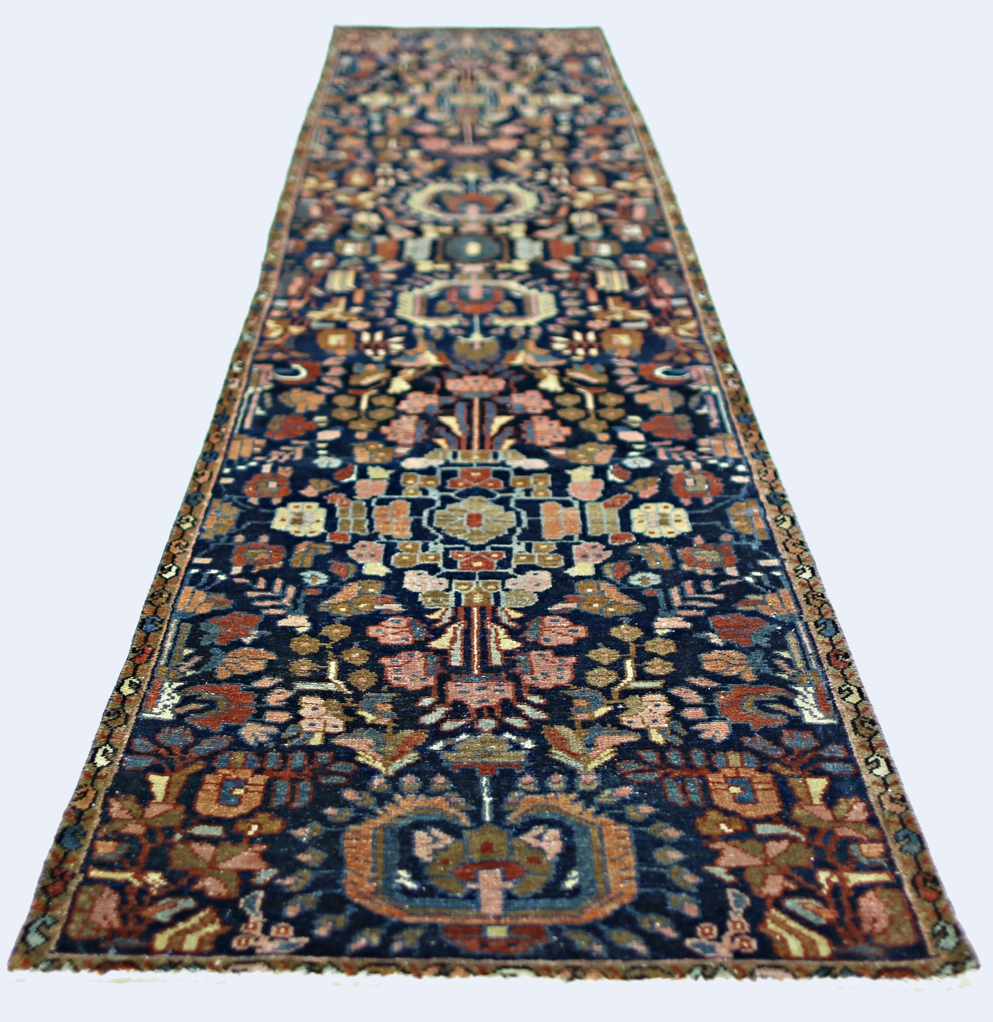 A vintage Persian Malayer runner featuring a dark blue field with intricate floral patterns.