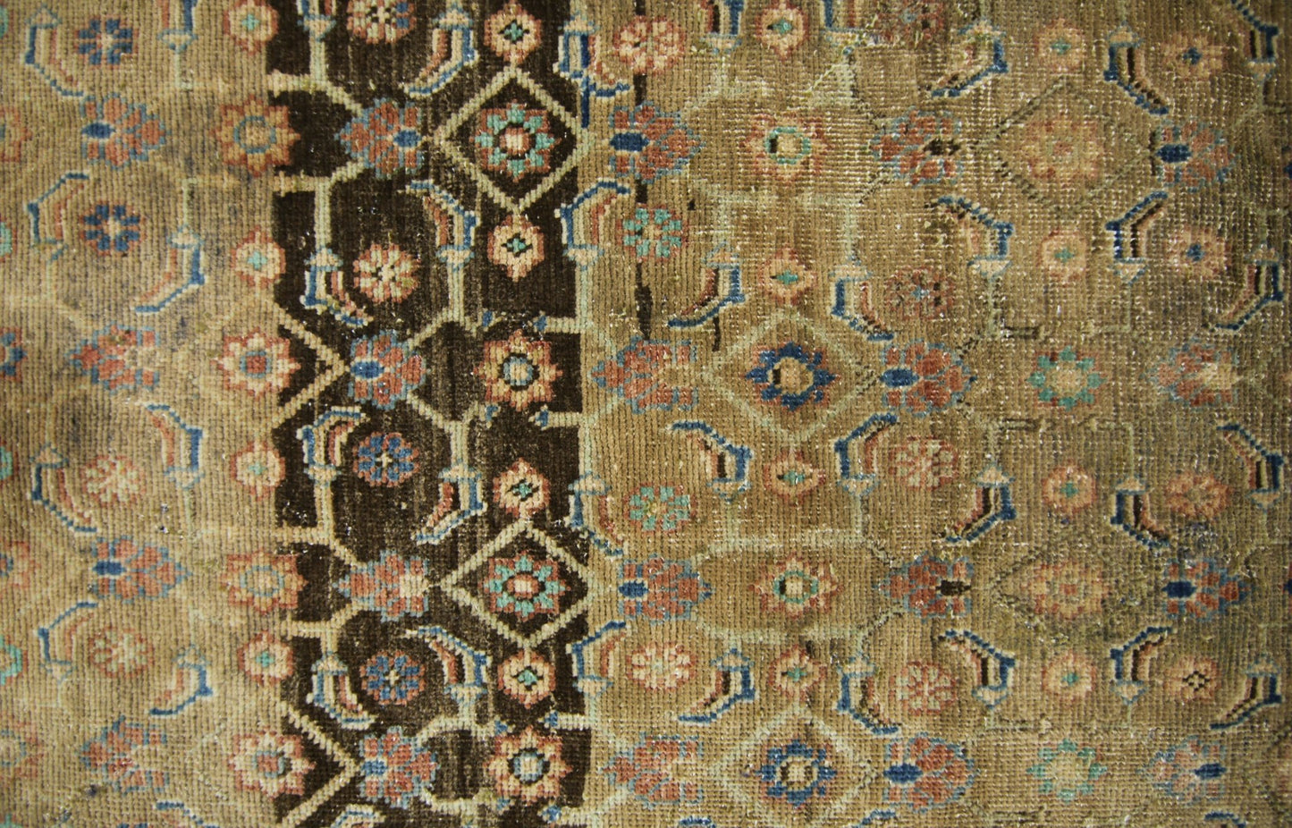 A vintage Persian Hamadan runner featuring a geometric floral pattern in brown, blue, and tan.
