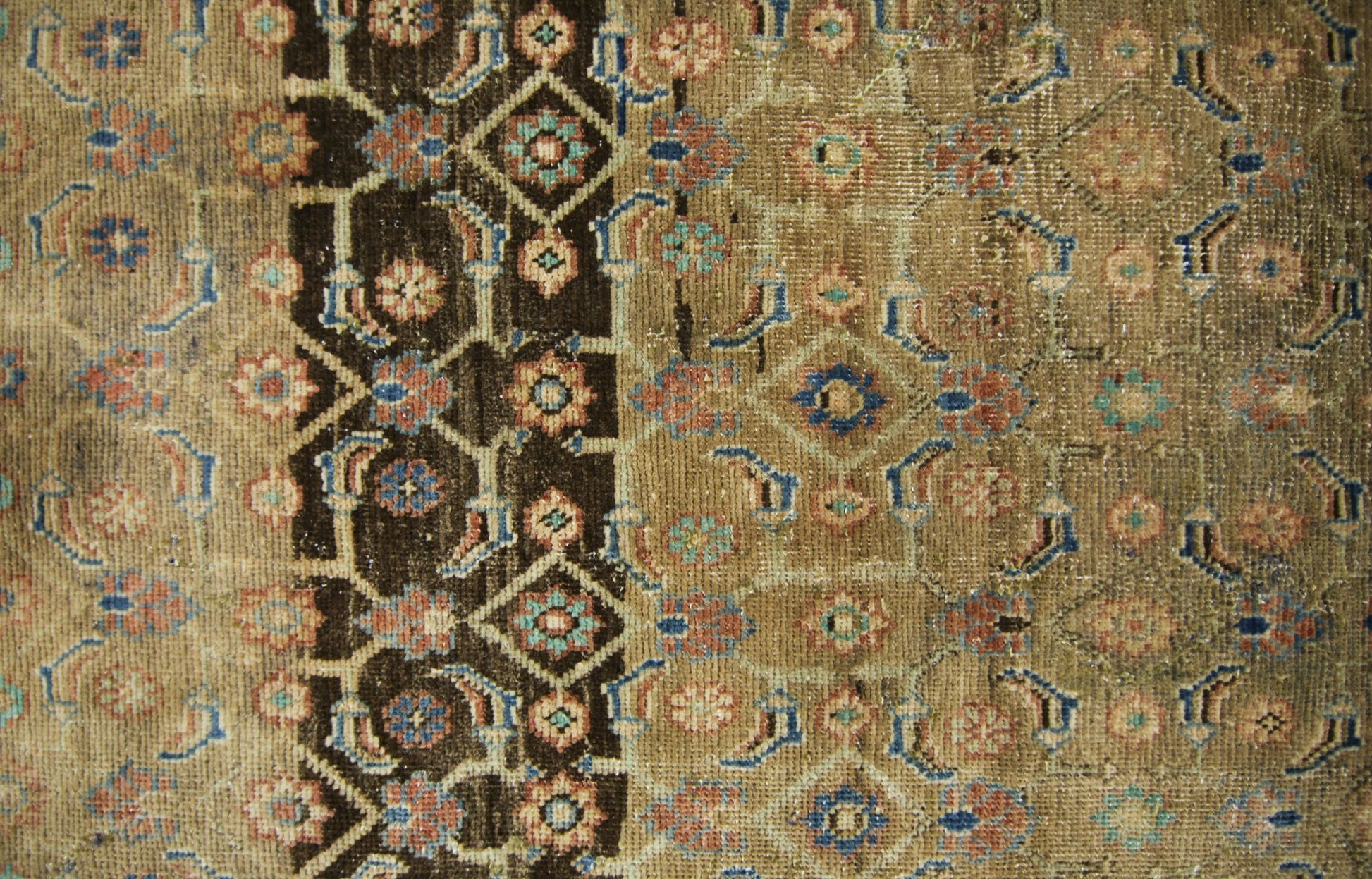 A vintage Persian Hamadan runner featuring a geometric floral pattern in brown, blue, and tan.