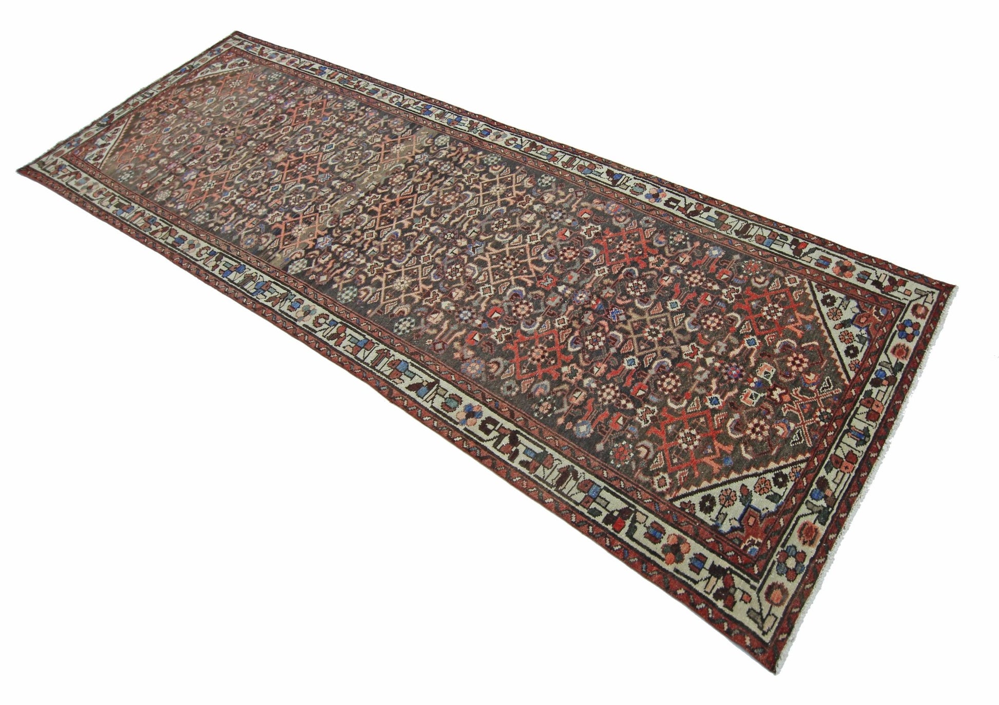 A vintage Persian Hamadan runner rug featuring a detailed geometric pattern in earthy tones.