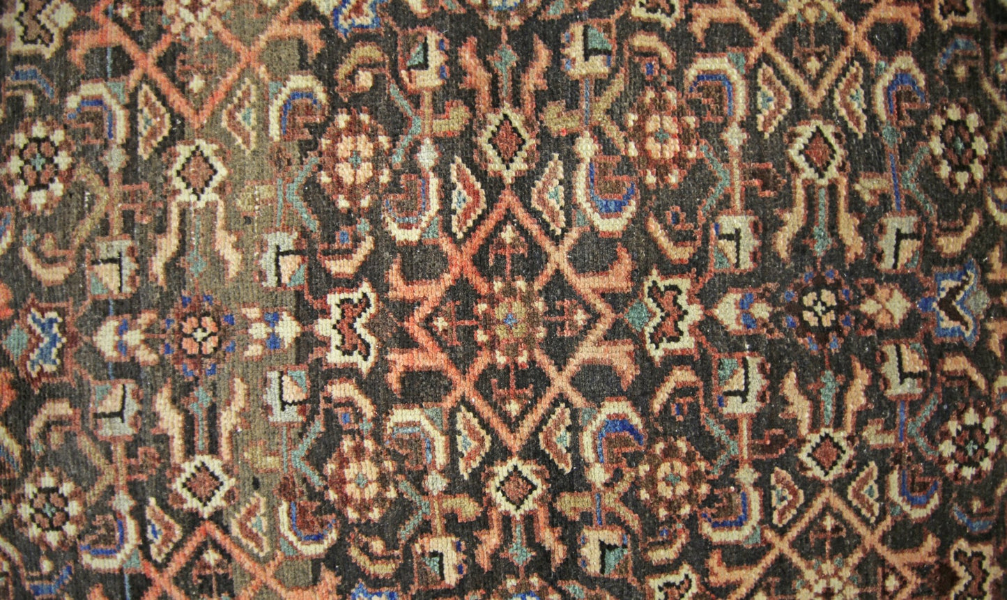 A vintage Persian Hamadan runner featuring a detailed geometric floral pattern in wool.