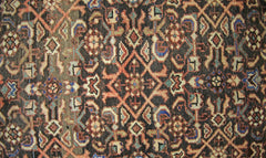 A vintage Persian Hamadan runner featuring a detailed geometric floral pattern in wool.