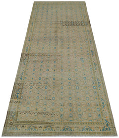 A vintage Persian Hamadan runner featuring a faded geometric pattern in blue and beige tones.