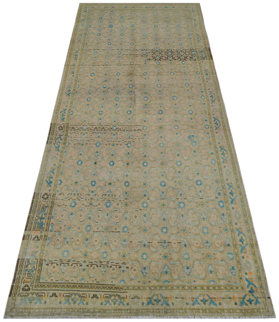 A vintage Persian Hamadan runner featuring a faded geometric pattern in blue and beige tones.