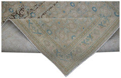 A vintage Persian Hamadan runner featuring a faded beige pattern with blue and brown accents.