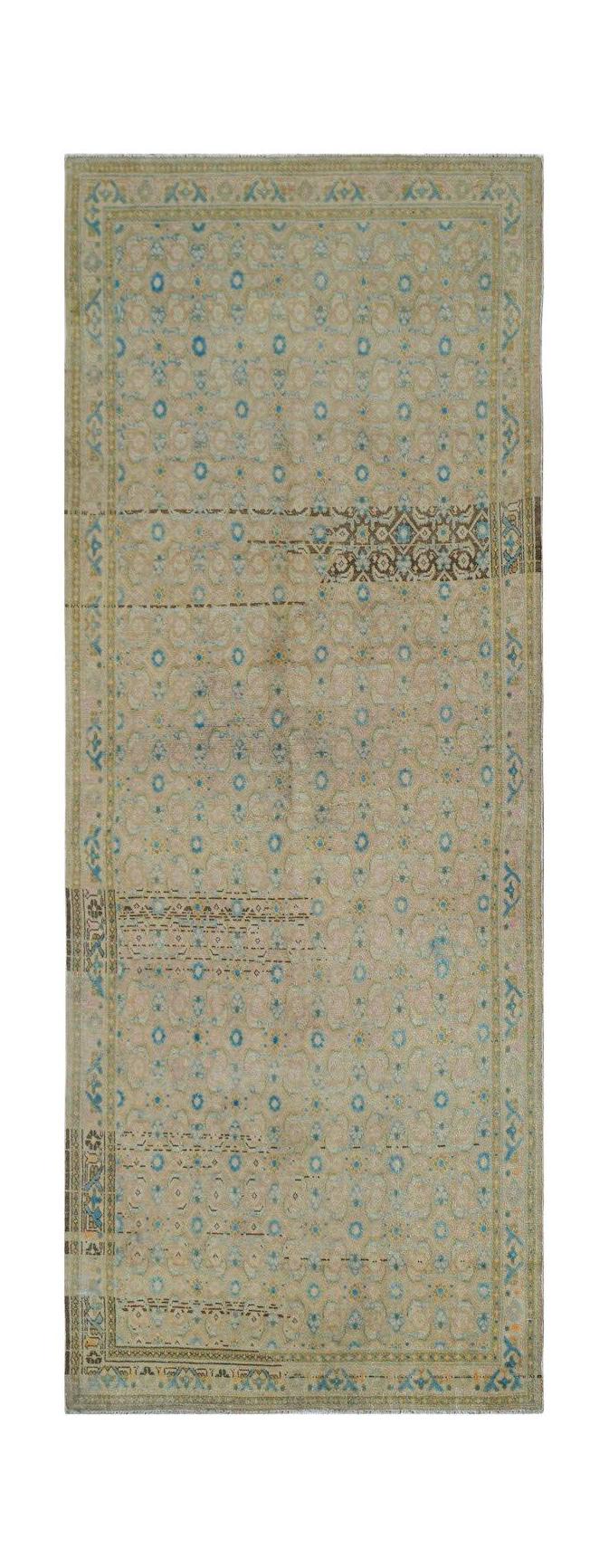 A vintage handwoven Persian Hamadan runner featuring a faded floral pattern in blue and beige.