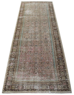A vintage Persian Hamadan runner rug featuring a faded brown pattern with blue and pink accents.