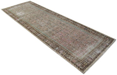 A vintage Persian Hamadan runner rug featuring a faded brown and pink geometric pattern.