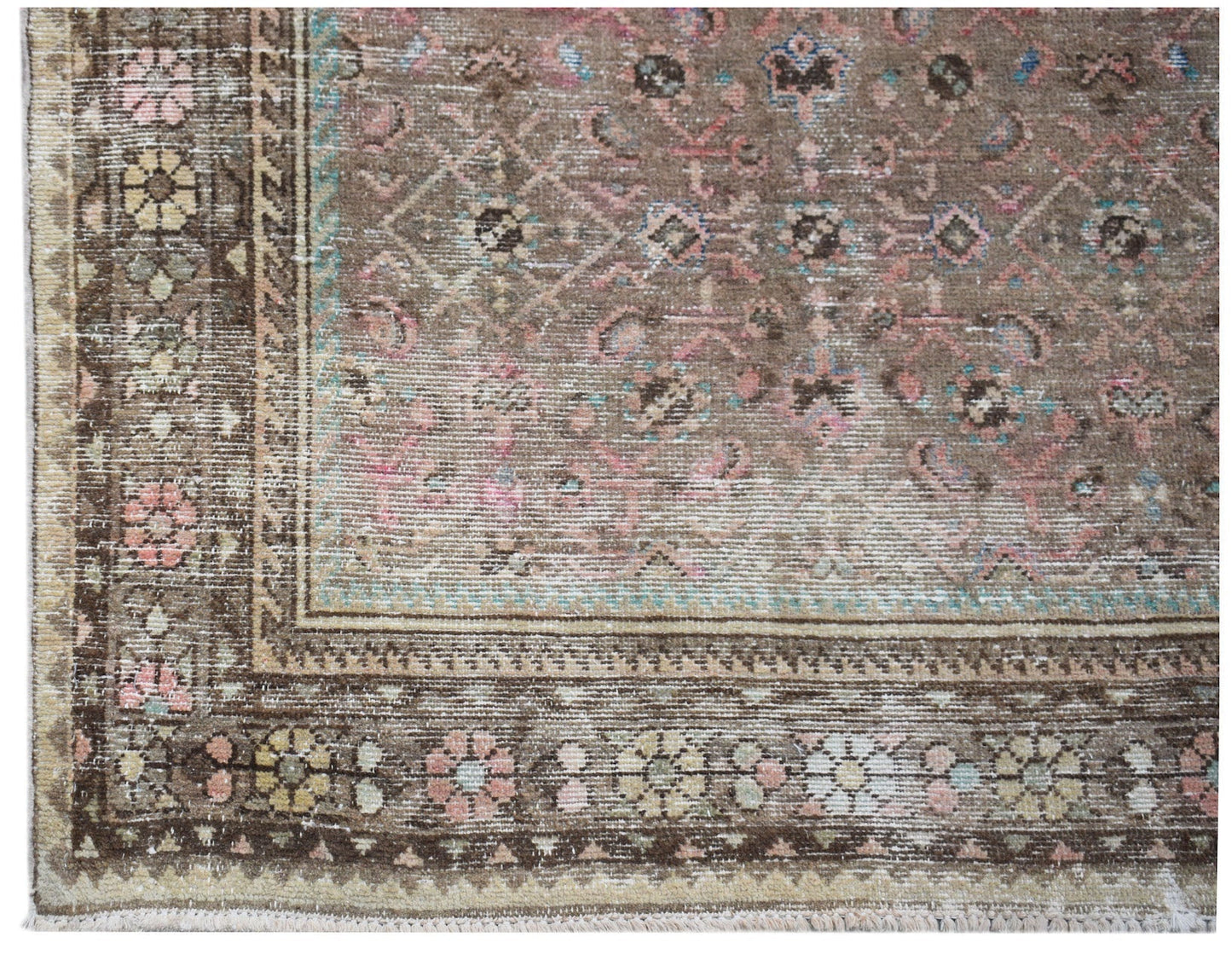 A vintage Persian Hamadan runner featuring a faded brown field with pink and blue floral motifs.