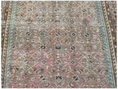 A vintage Persian Hamadan runner featuring a faded brown geometric pattern with blue and pink accents.