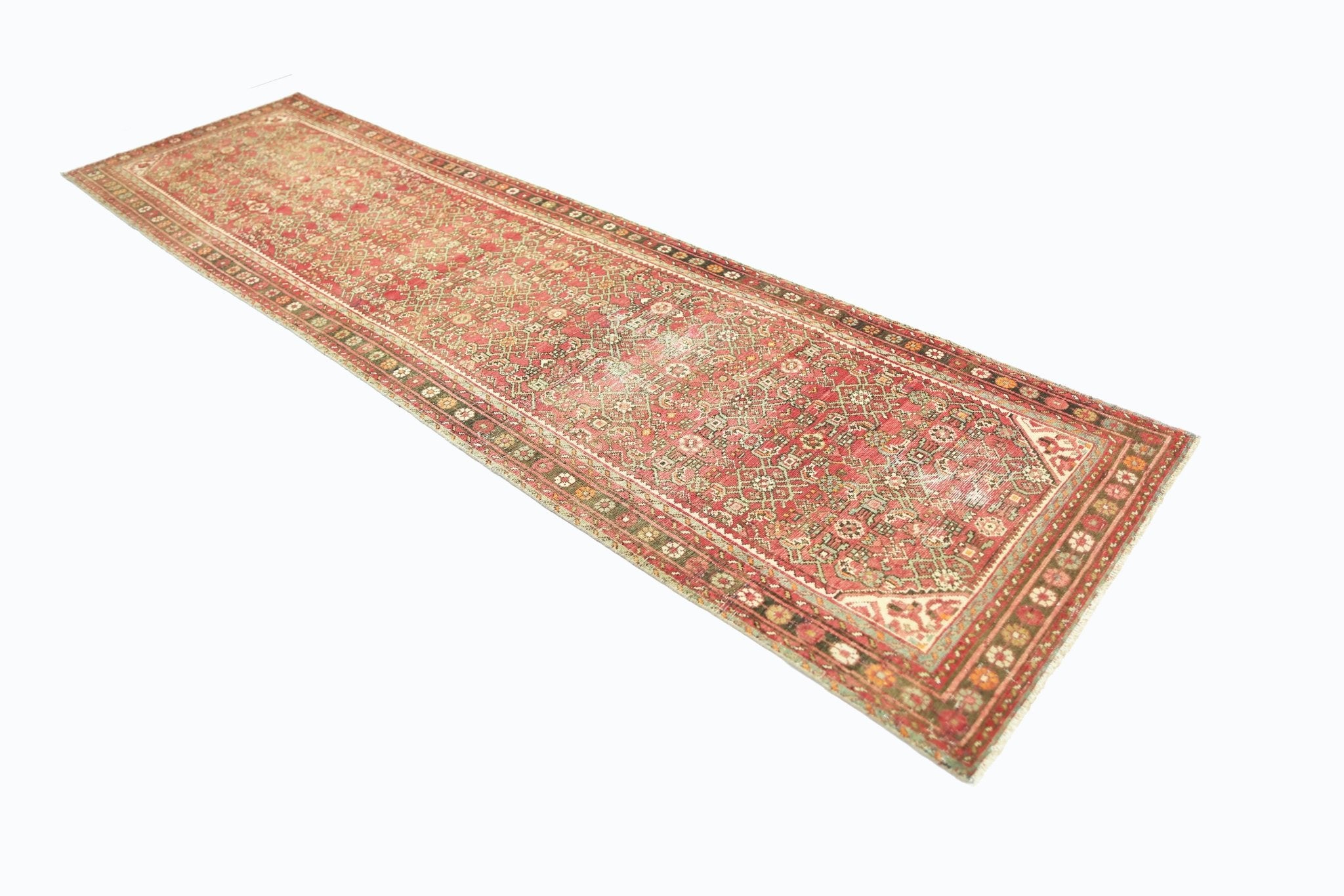 A vintage Persian Hamadan runner rug featuring intricate geometric patterns in red and beige tones.