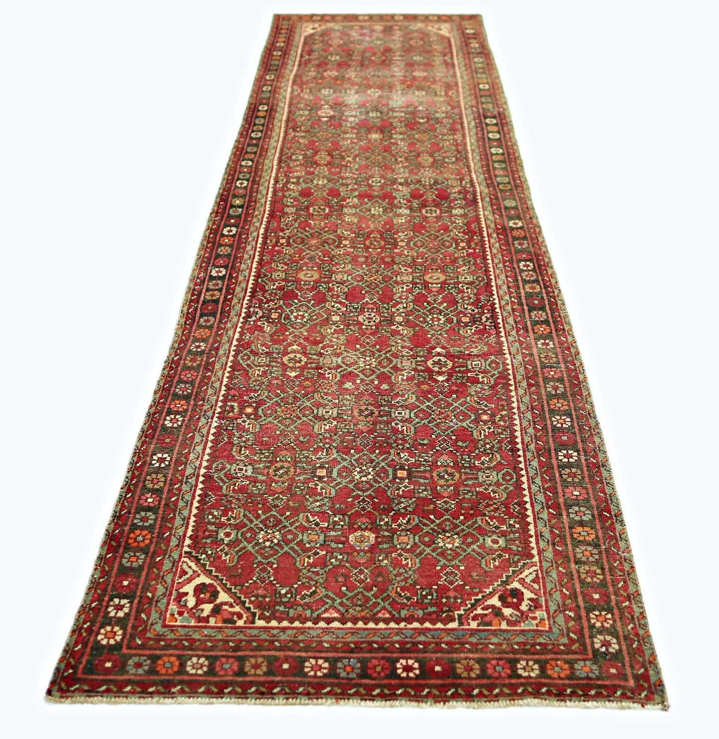 A vintage Persian Hamadan runner rug featuring a red field with intricate geometric patterns.