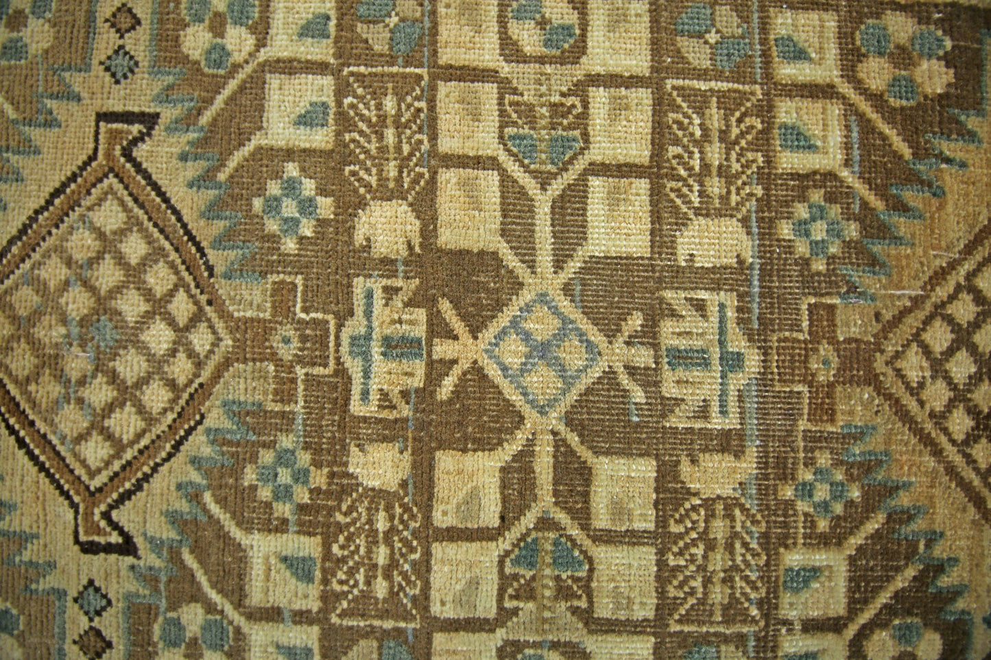 A vintage Persian Malayer runner featuring intricate geometric patterns in brown and blue tones.