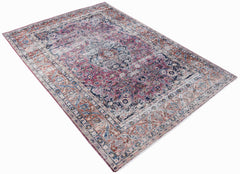A vintage Persian Mashhad rug featuring intricate floral patterns in shades of pink, blue, and rust.