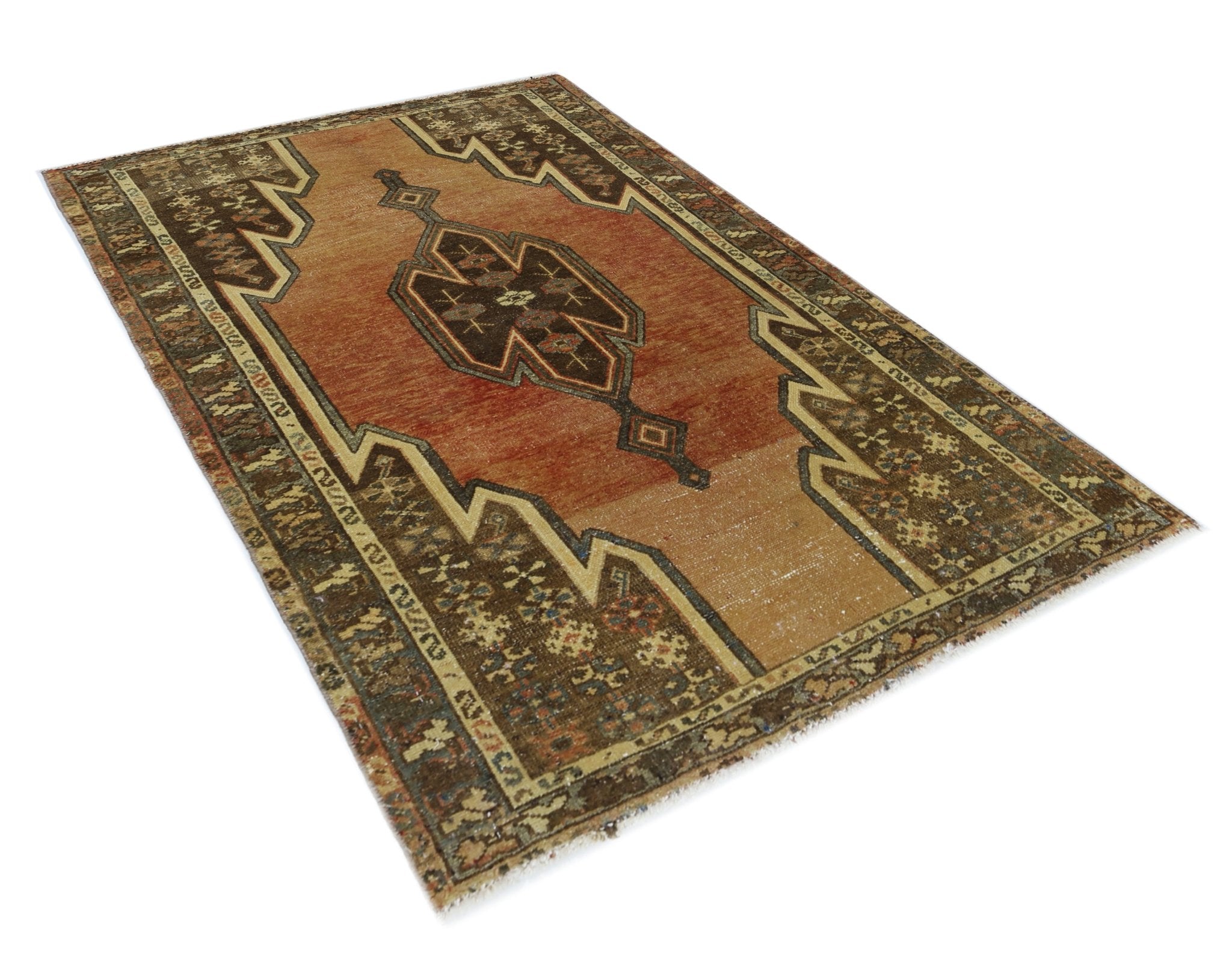 A vintage Persian Mazlaghan rug featuring a geometric medallion on a rust and tan field.