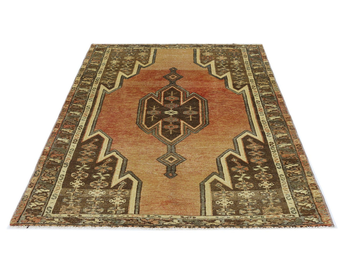 A vintage Persian Mazlaghan rug featuring a geometric central medallion on a rust-colored field.