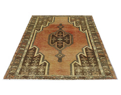 A vintage Persian Mazlaghan rug featuring a geometric central medallion on a rust-colored field.