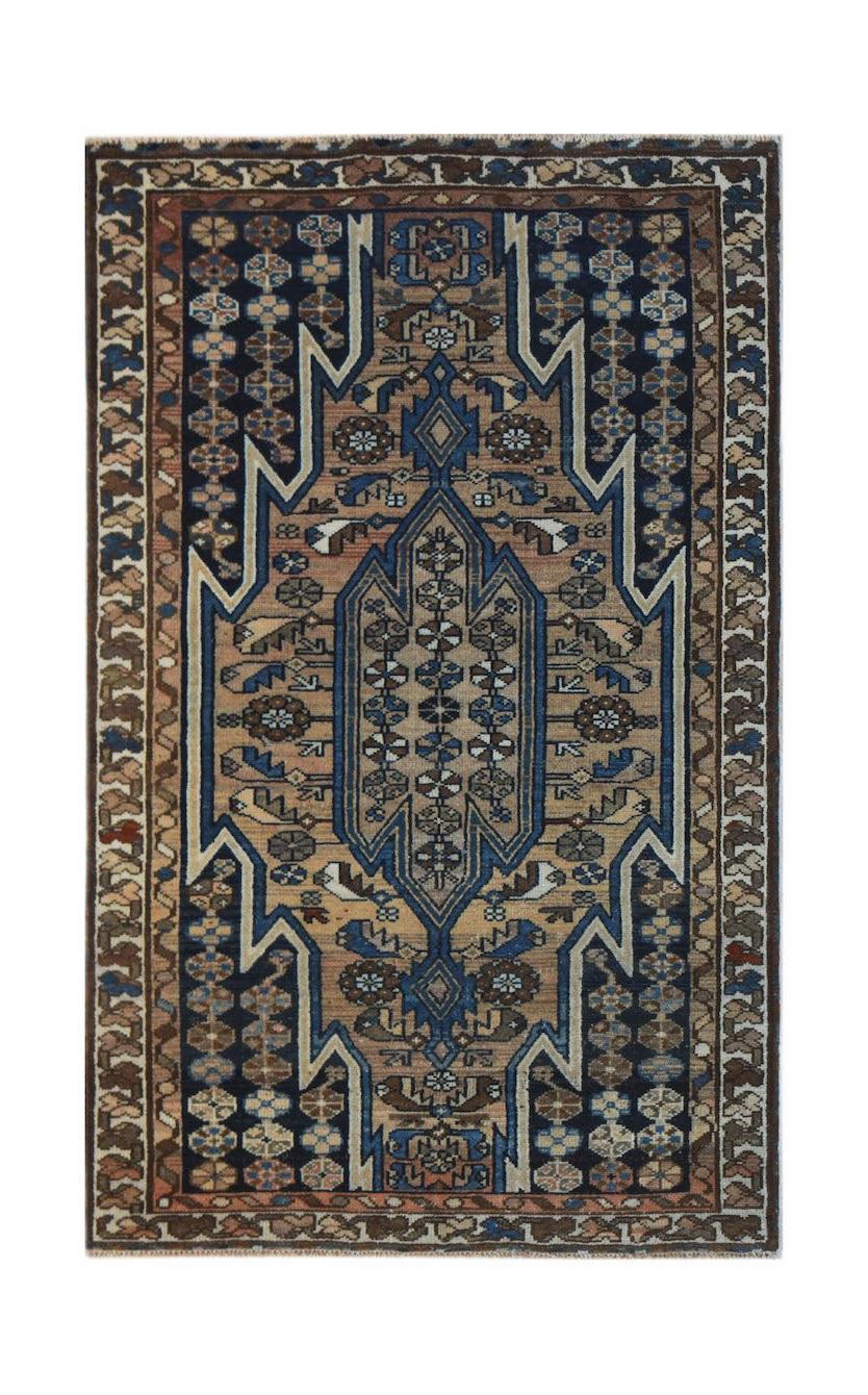 A vintage Persian Mazlaghan rug featuring a geometric central medallion in blue and tan tones.