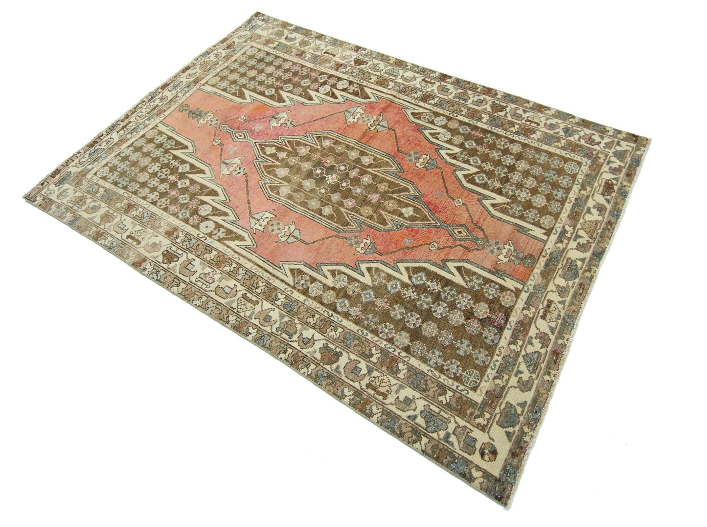 A vintage Persian Mazlaghan rug featuring a central geometric medallion on a salmon and brown field.