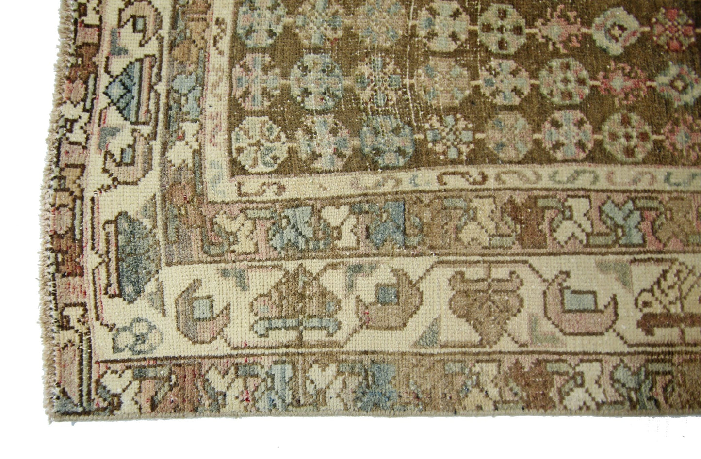 A vintage Persian Mazlaghan rug featuring a brown field with geometric patterns and a cream border.