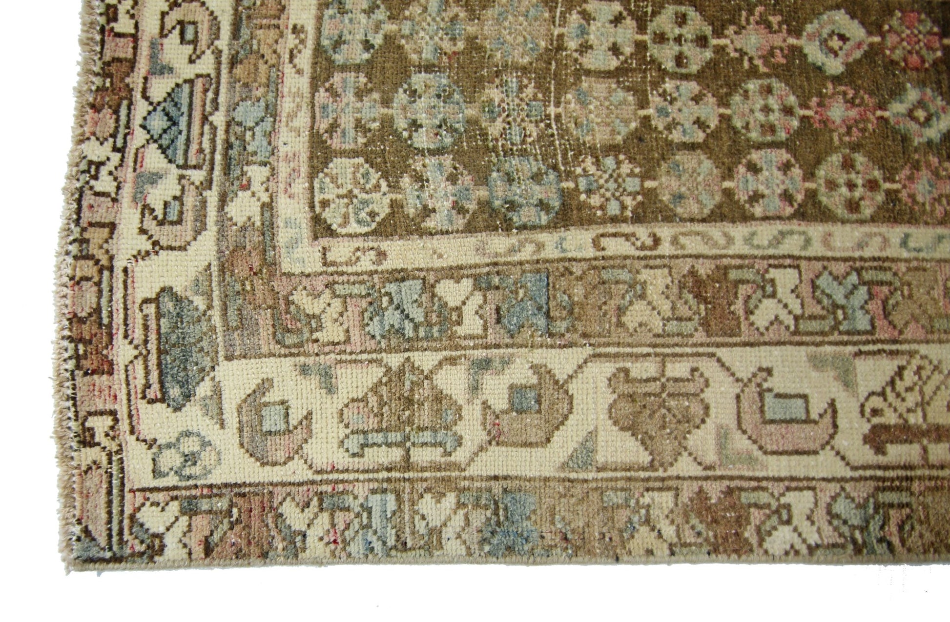 A vintage Persian Mazlaghan rug featuring a brown field with geometric patterns and a cream border.