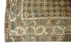 A vintage Persian Mazlaghan rug featuring a brown field with geometric patterns and a cream border.