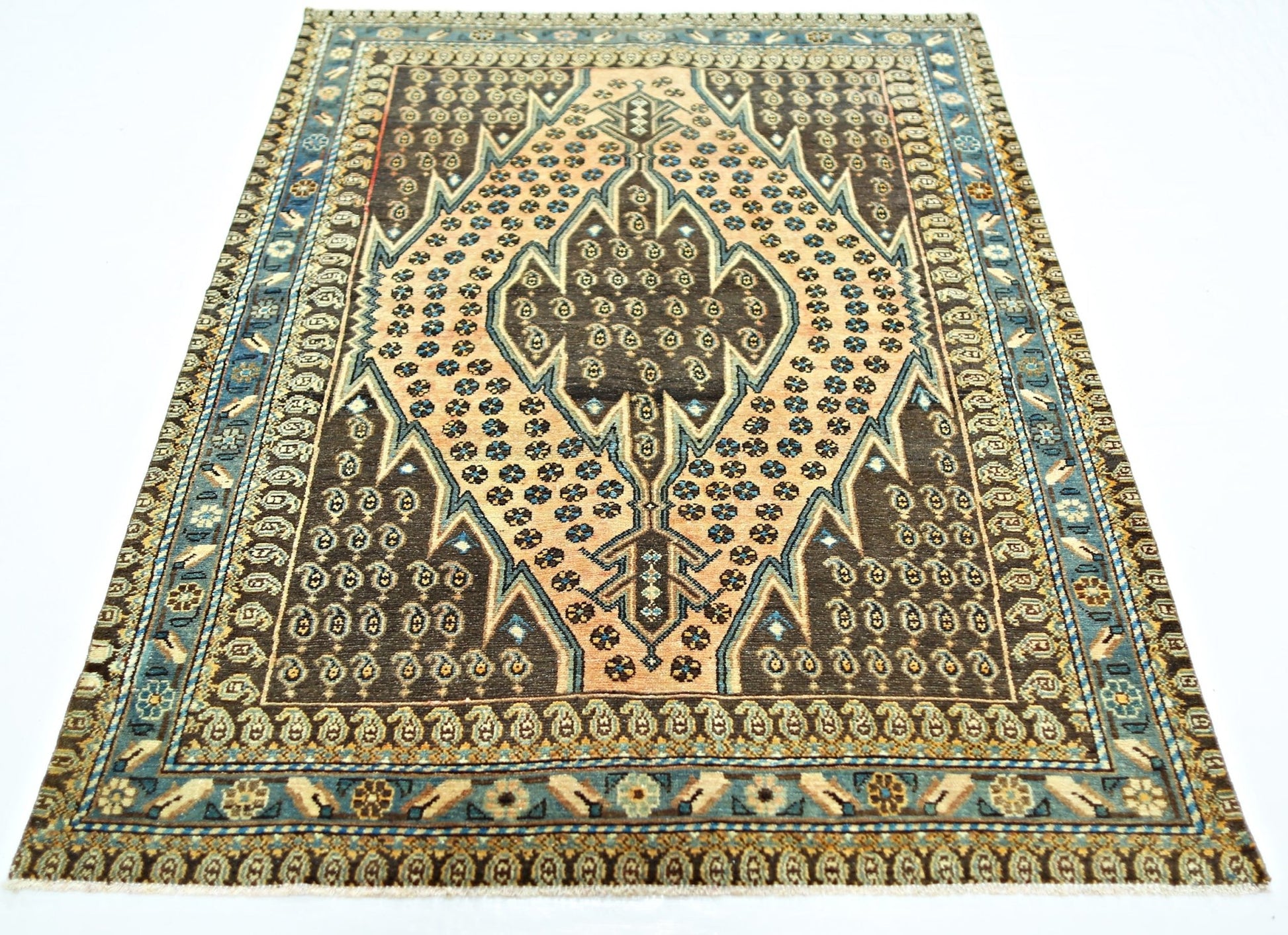 A vintage Persian Mazlaghan rug featuring a central diamond medallion on a brown and tan field.