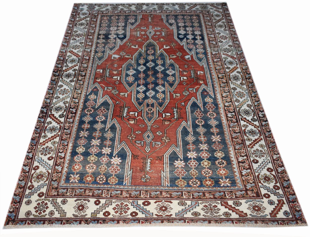 A vintage handwoven Persian Mazlaghan rug featuring a geometric medallion on a red and blue field.