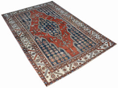 A vintage handwoven Persian Mazlaghan rug featuring a geometric medallion on a red and blue field.