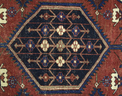 A vintage Persian Mazlaghan rug featuring a central dark blue hexagon with geometric floral motifs.