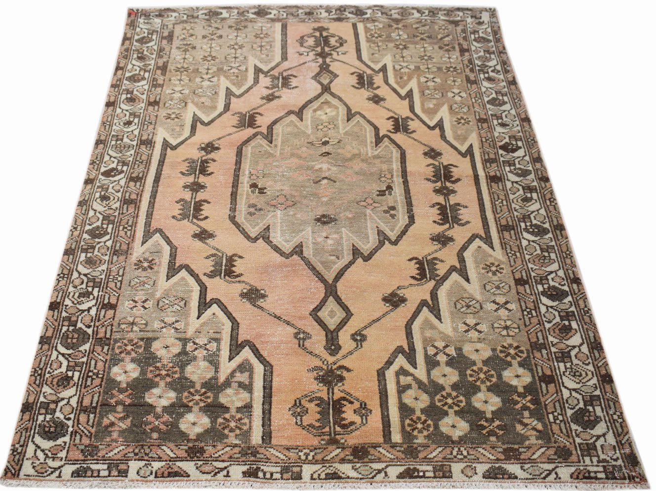Vintage Persian Mazlaghan rug featuring a geometric medallion in muted peach and brown tones.