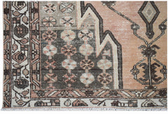 A vintage Persian Mazlaghan rug featuring geometric patterns in muted peach, grey, and brown tones.