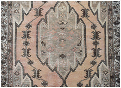A vintage Persian Mazlaghan rug featuring a central geometric medallion in muted peach and grey.