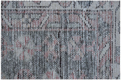 A close-up view of a vintage Persian Mazlaghan rug featuring a faded geometric pattern in wool.
