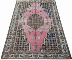 Vintage Persian Mazlaghan rug featuring a pink diamond medallion, geometric brown and navy patterns, and a floral border.