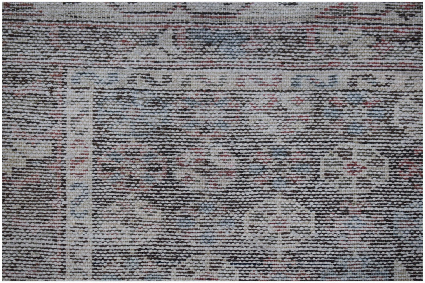 A vintage Persian Mazlaghan rug featuring a dark, intricate geometric pattern on a wool pile.