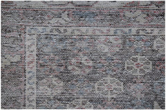 A vintage Persian Mazlaghan rug featuring a dark, intricate geometric pattern on a wool pile.