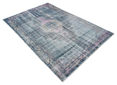 A vintage Persian rug featuring a distressed blue and pink pattern on a wool and cotton base.