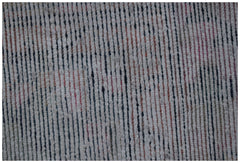 A close-up of a vintage Persian rug featuring a textured, handwoven pattern of vertical stripes.