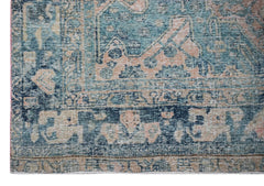 A vintage Persian Mazlaghan rug featuring a distressed teal and peach geometric floral pattern.