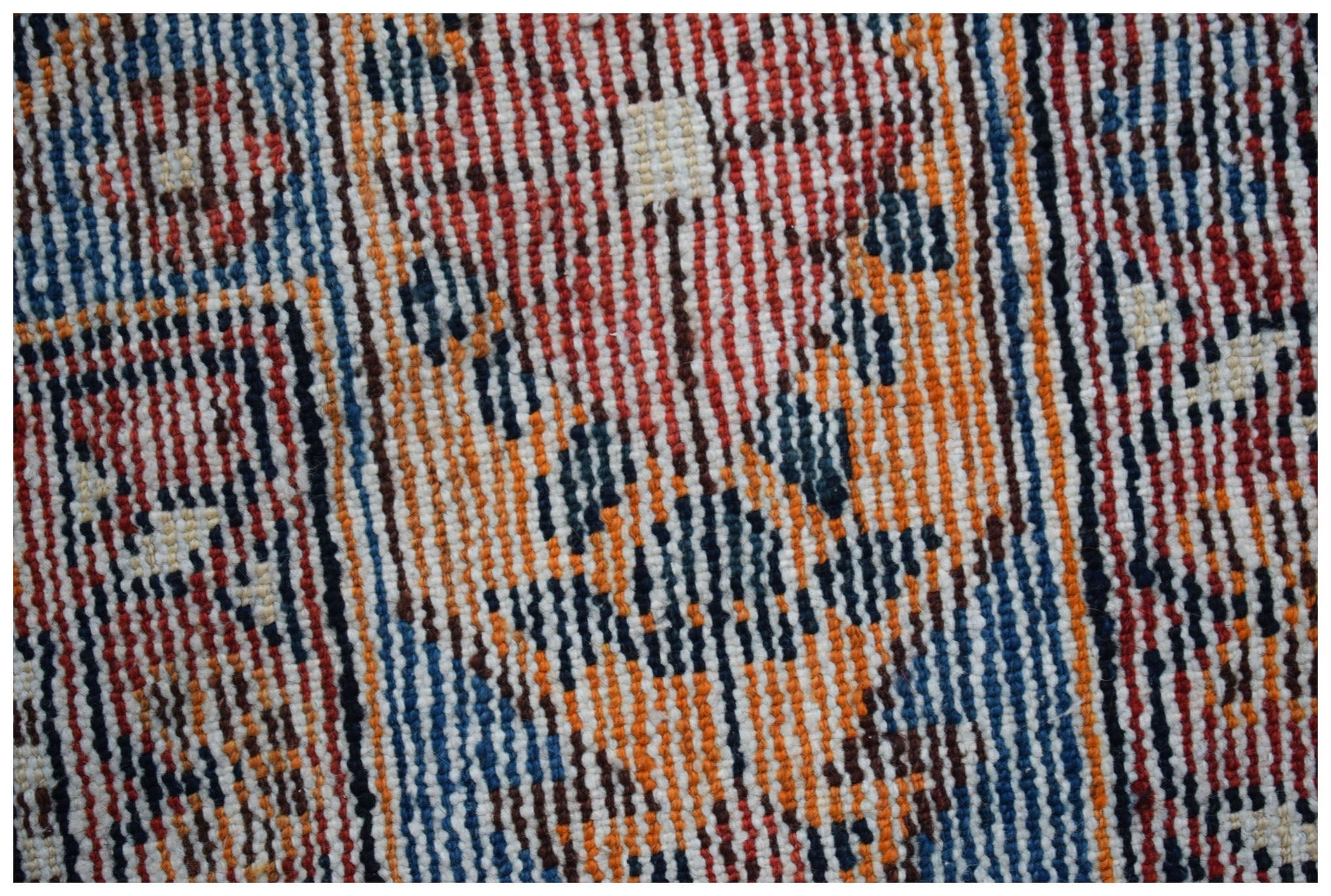 A close-up view of a handwoven vintage Persian rug featuring intricate geometric patterns.