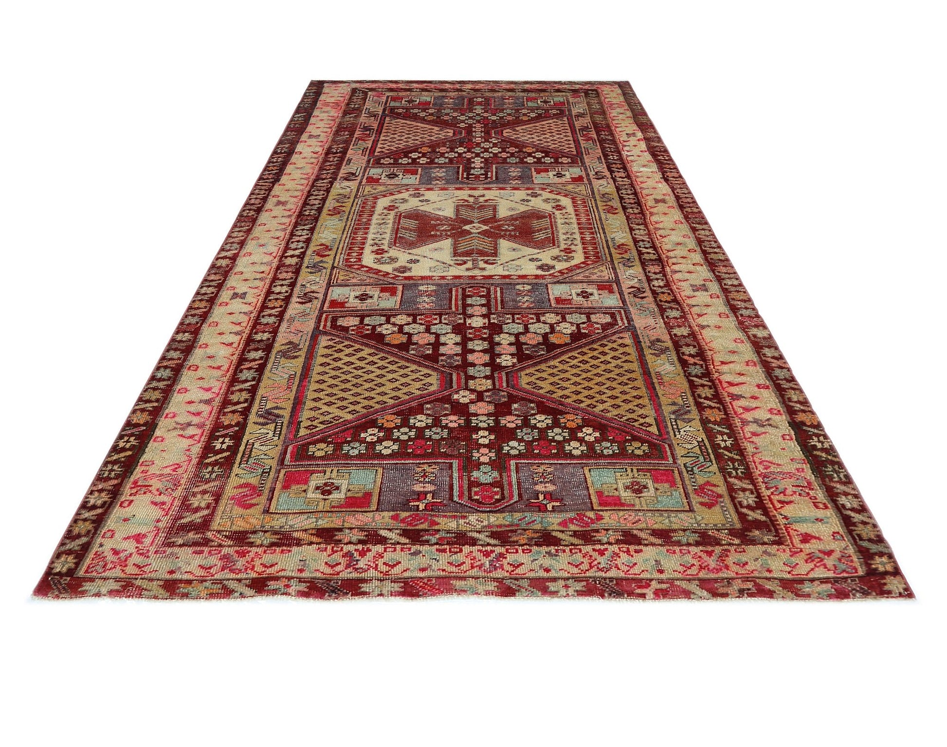 A vintage Persian runner rug featuring a geometric pattern in shades of red, beige, and blue.