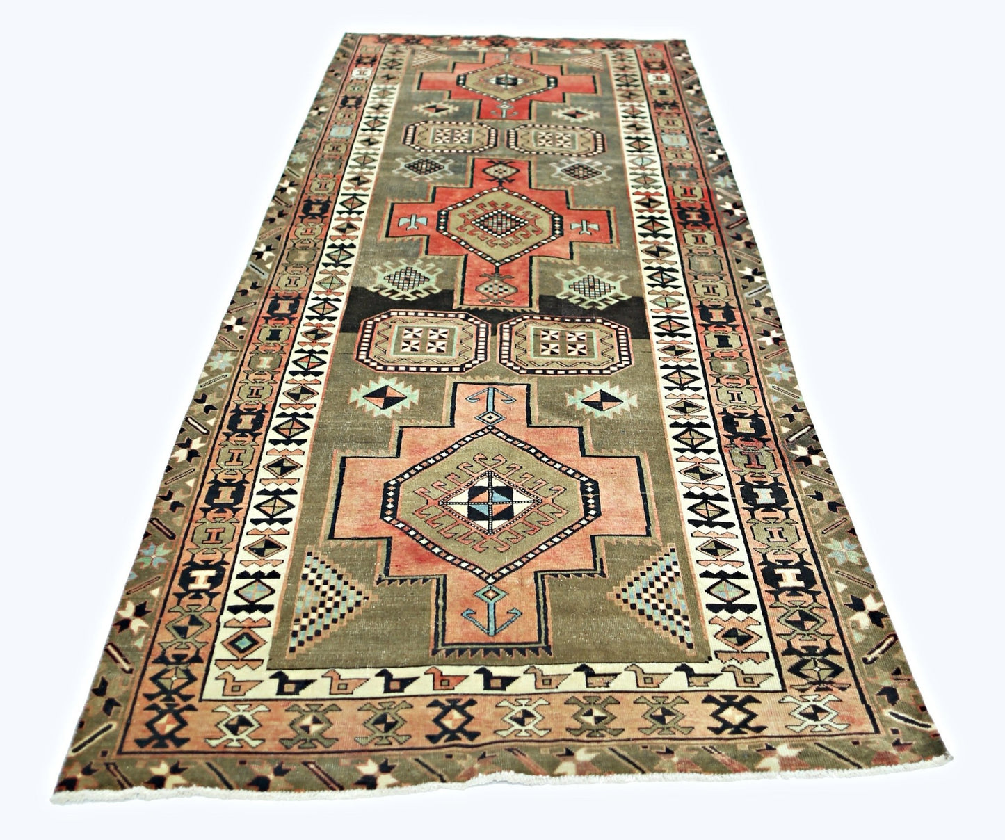 A vintage Persian Ardabil runner featuring geometric medallions in muted tones on a grey field.